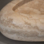 Close-up of Travertino Classico CC showing soft beige veining, natural pores and tonal variation.