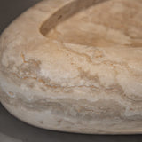 Close-up of Travertino Classico CC showing soft beige veining, natural pores and tonal variation.