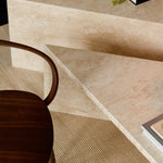 Angular Travertino Classico CC marble coffee tables close-up with warm-toned veining in a natural soft interior.