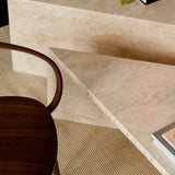 Angular Travertino Classico CC marble coffee tables close-up with warm-toned veining in a natural soft interior.