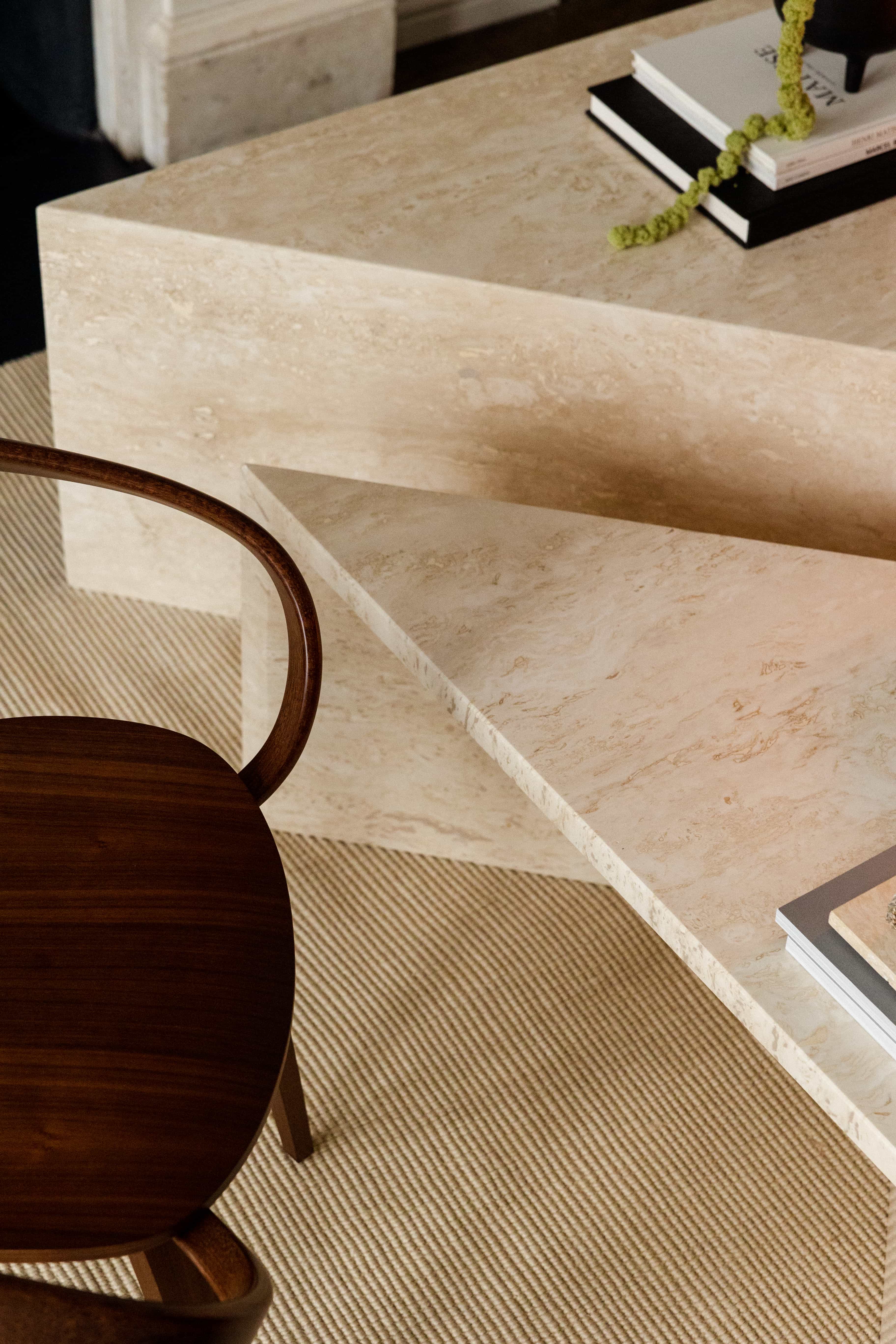 Angular Travertino Classico CC marble coffee tables close-up with warm-toned veining in a natural soft interior.